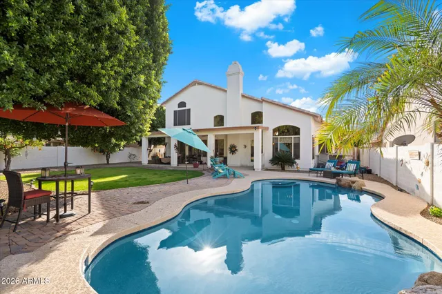 a view of a house with swimming pool and sitting area