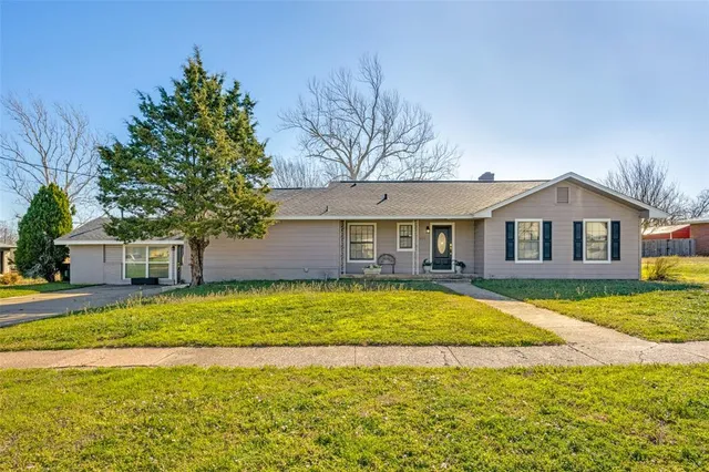 a front view of house with yard and swimming pool