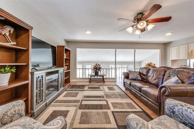 a living room with furniture fireplace and a large window