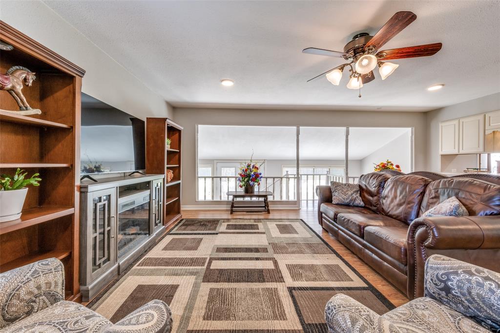 909 Coffield Street Bowie, TX 76230 - Photo 13 of 25 a living room with furniture fireplace and a large window