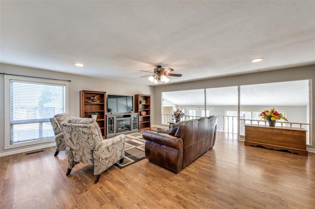 909 Coffield Street Bowie, TX 76230 - Photo 15 of 25 a living room with furniture and a large window