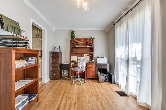 a view of a workspace with furniture and wooden floor
