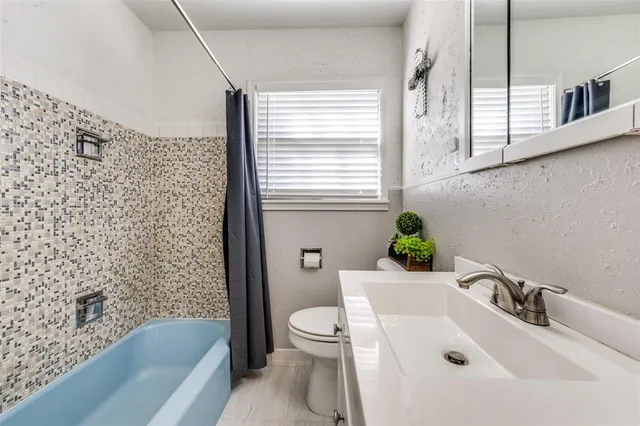 a bathroom with a sink a toilet and a bathtub