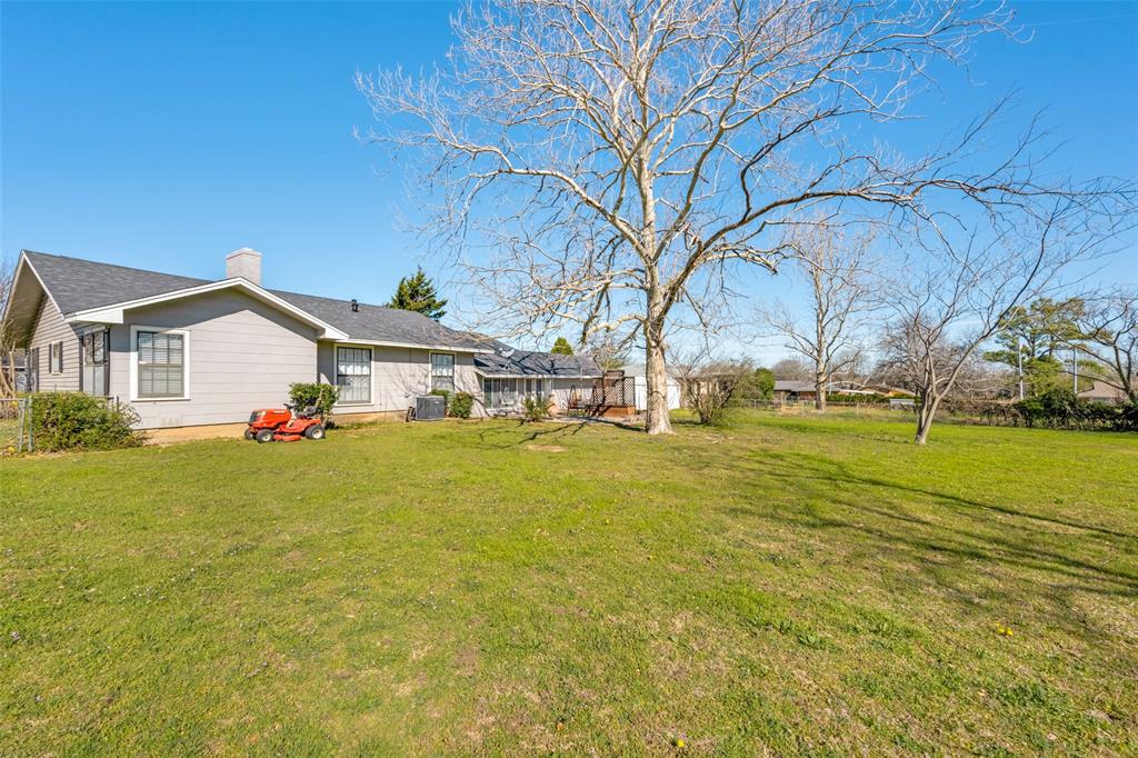 909 Coffield Street Bowie, TX 76230 - Photo 25 of 25 a view of a house with a yard