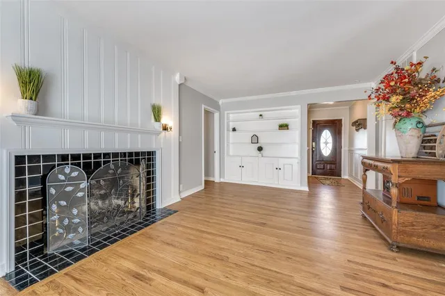 a view of a livingroom with wooden floor and a fireplace