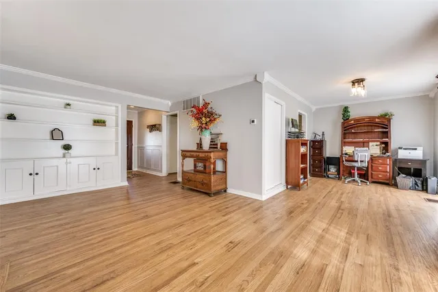 a view of a livingroom with furniture and an empty room