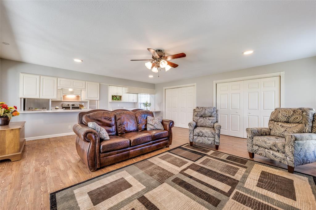 909 Coffield Street Bowie, TX 76230 - Photo 7 of 25 a living room with furniture and a chandelier