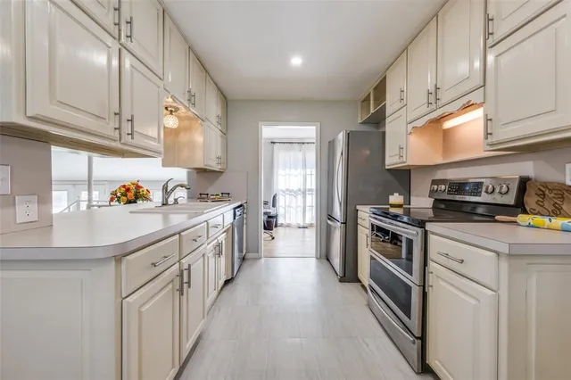 a kitchen with kitchen island granite countertop lots of counter top space stainless steel appliances and cabinets