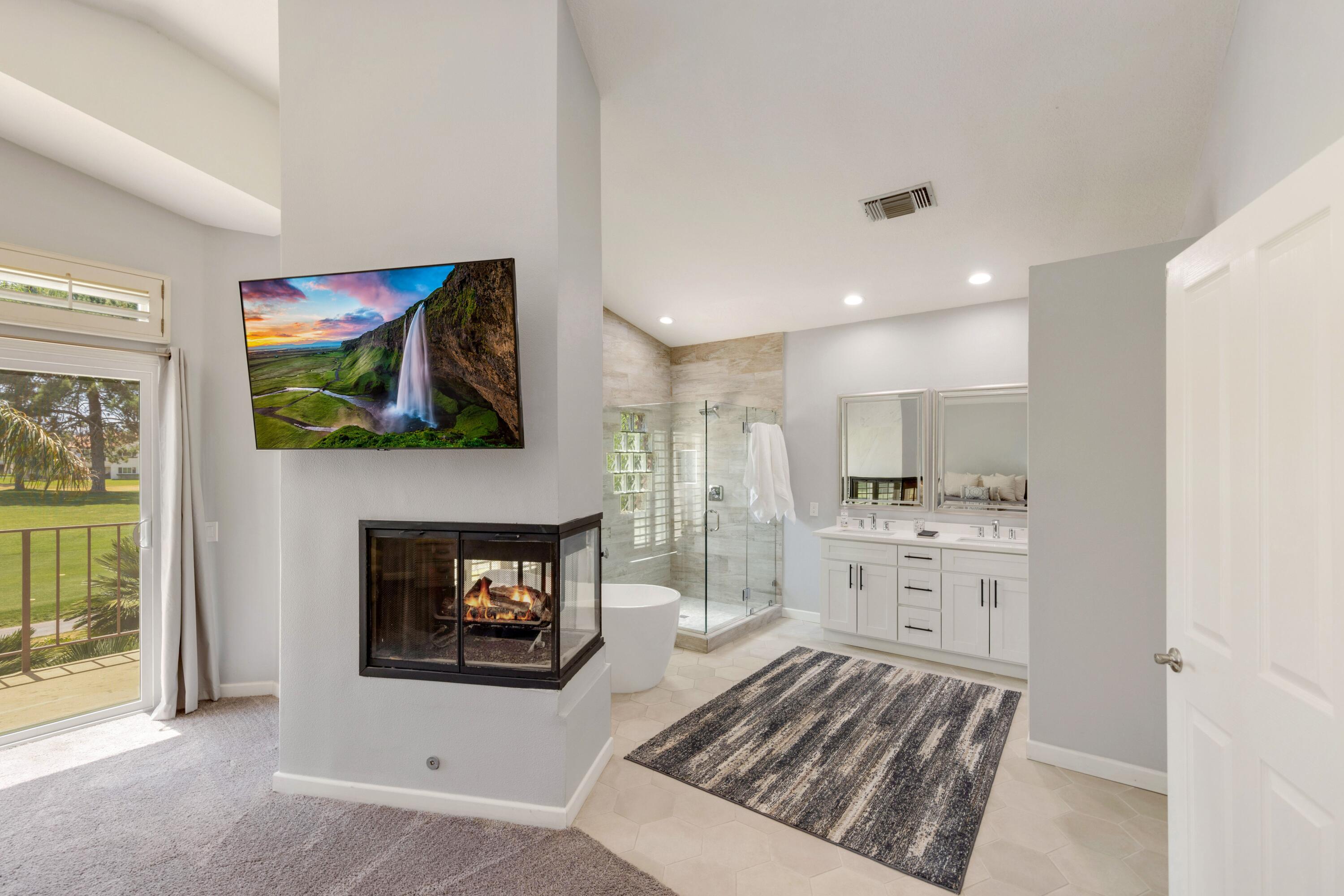 351 Augusta Drive Palm Desert, CA 92211 - Photo 13 of 26 a living room with stainless steel appliances furniture a fireplace and a flat screen tv