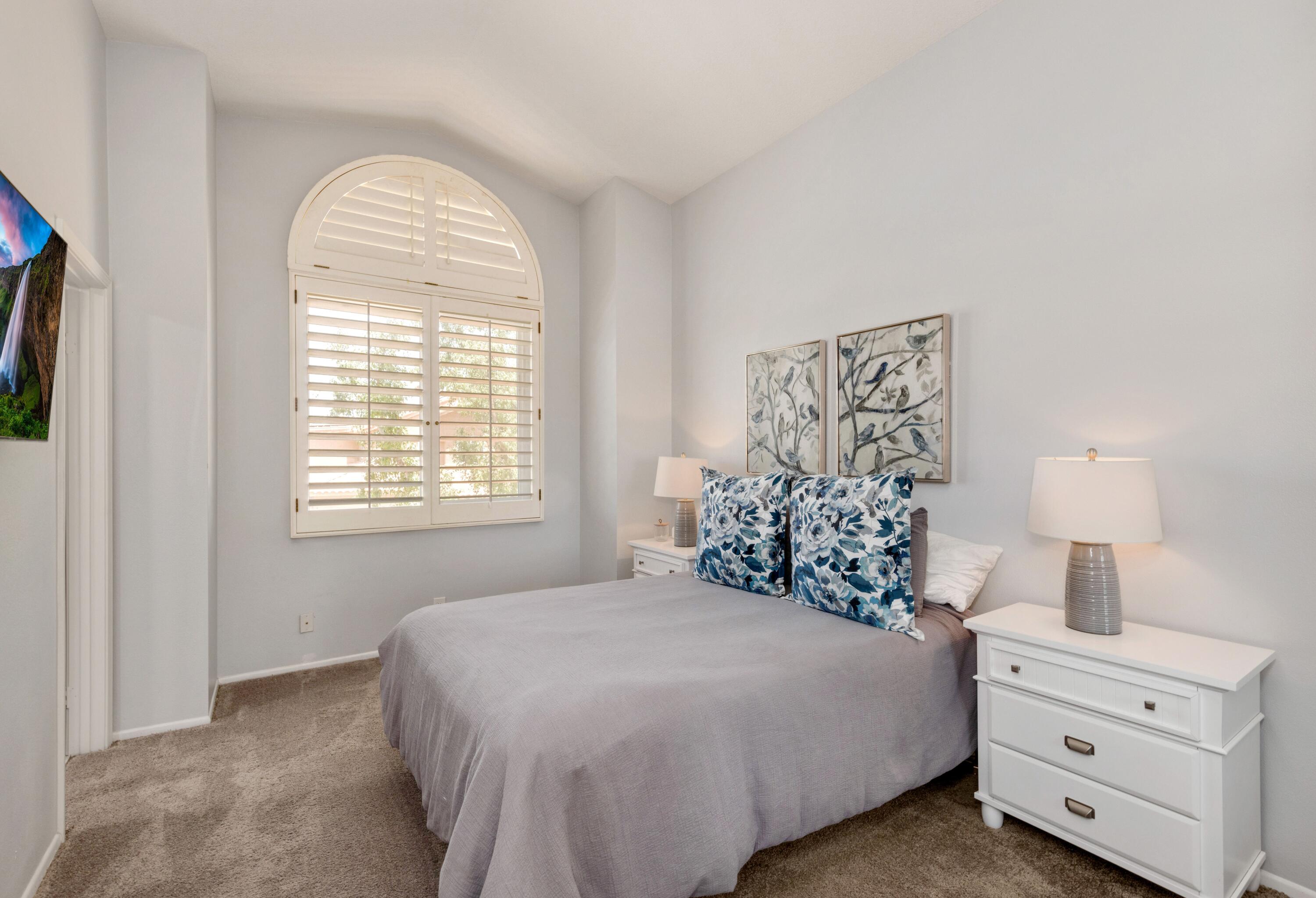 351 Augusta Drive Palm Desert, CA 92211 - Photo 17 of 26 a bedroom with a bed and a window