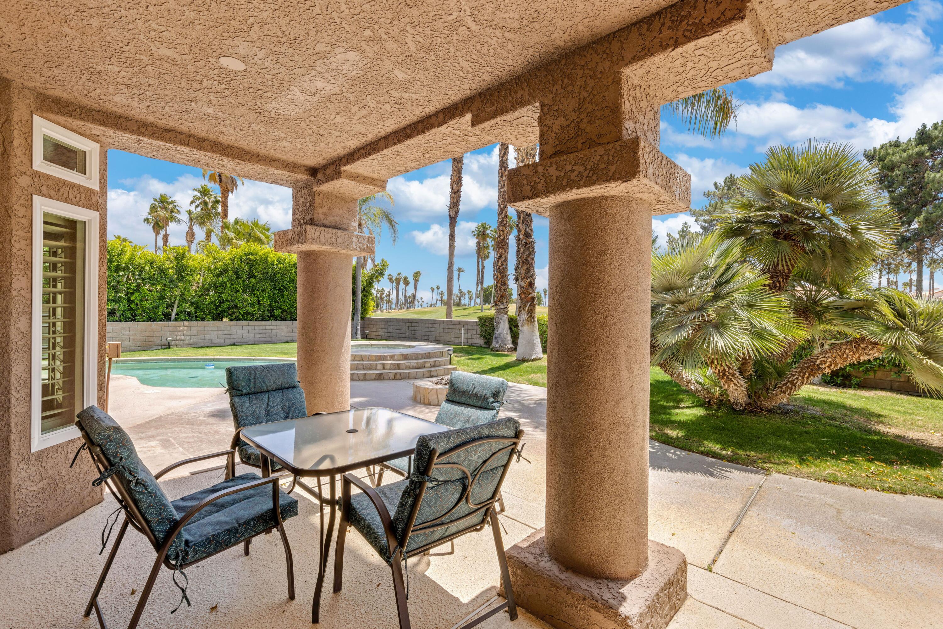 351 Augusta Drive Palm Desert, CA 92211 - Photo 20 of 26 a view of a patio with table and chairs and potted plants
