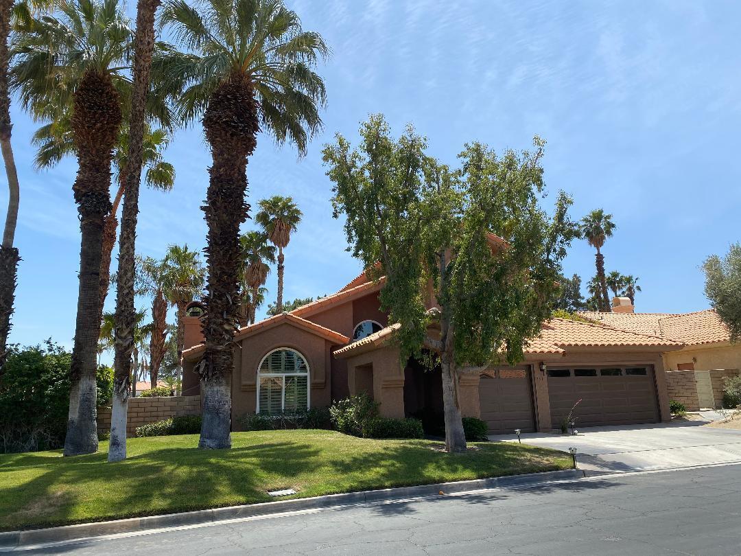 351 Augusta Drive Palm Desert, CA 92211 - Photo 2 of 26 a front view of a house with a garden and tree