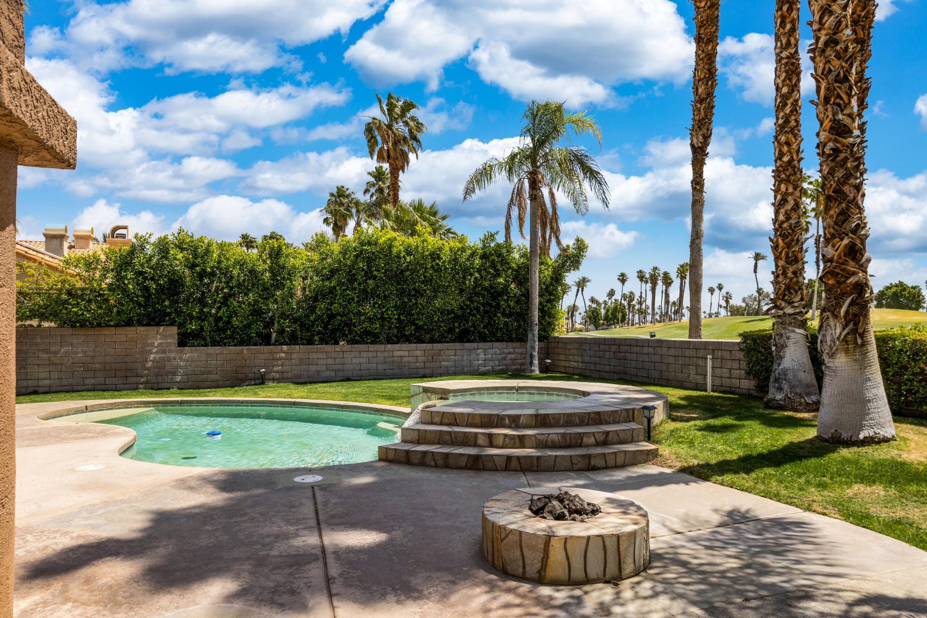 351 Augusta Drive Palm Desert, CA 92211 - Photo 5 of 26 a view of a swimming pool with a yard