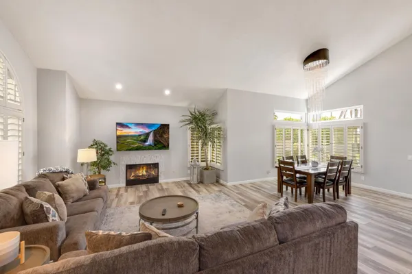 a living room with fireplace furniture and a flat screen tv