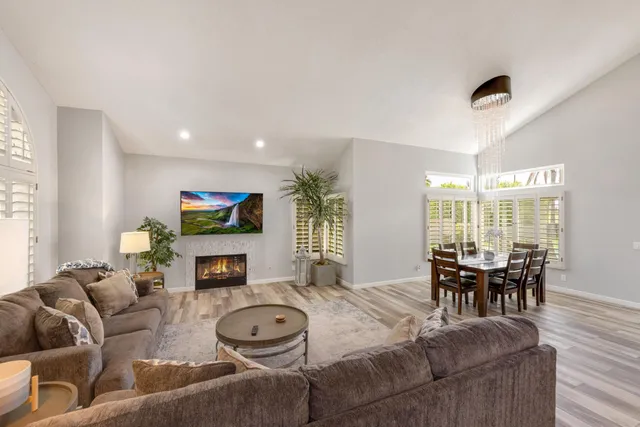 a living room with fireplace furniture and a flat screen tv