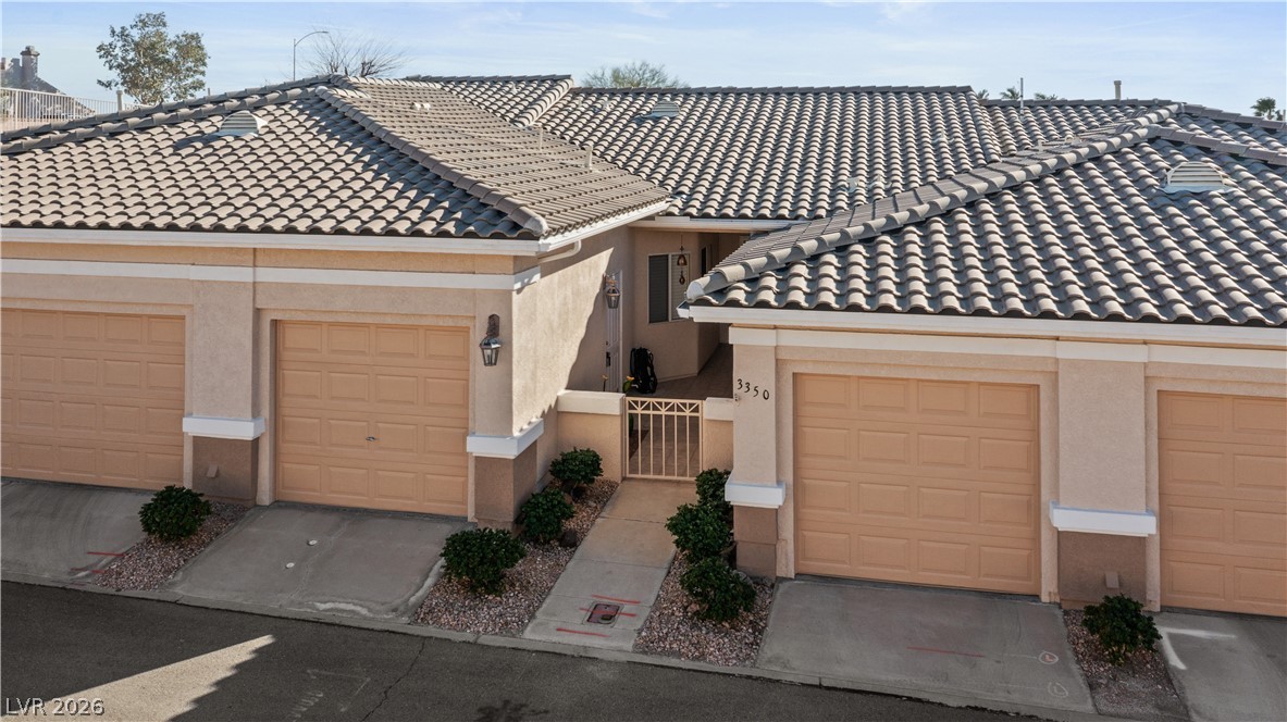 3350 Pheasant Canyon Way, Unit 1008 Laughlin, NV 89029 - Photo 70 of 80 View of front facade with a tile roof, stucco siding, a gate, and a garage