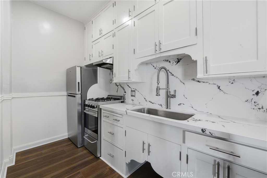 1030 East Ocean Boulevard, Unit 509 Long Beach, CA 90802 - Photo 13 of 39 a kitchen with sink cabinets and stainless steel appliances