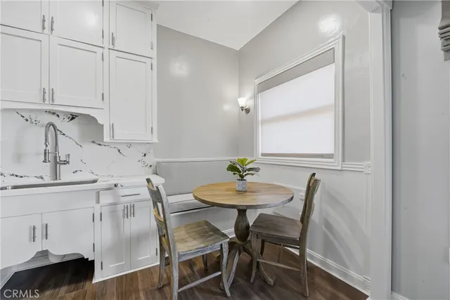 a view of a kitchen area with furniture and wooden floor