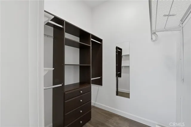 a view of closet with wooden floor