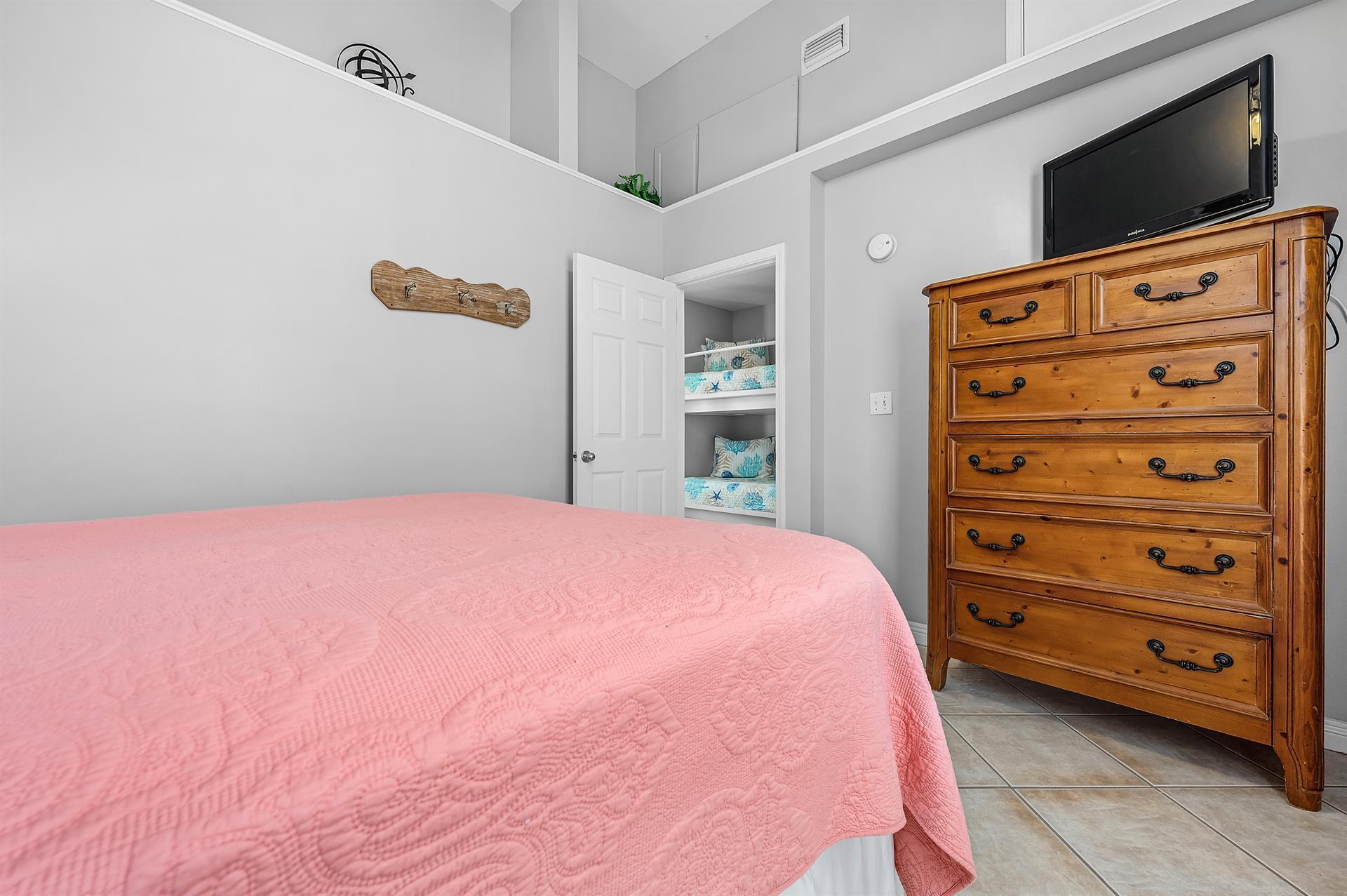69 Crystal Beach Drive, Unit 8 Destin, FL 32541 - Photo 11 of 51 a bedroom with a bed and a flat screen tv