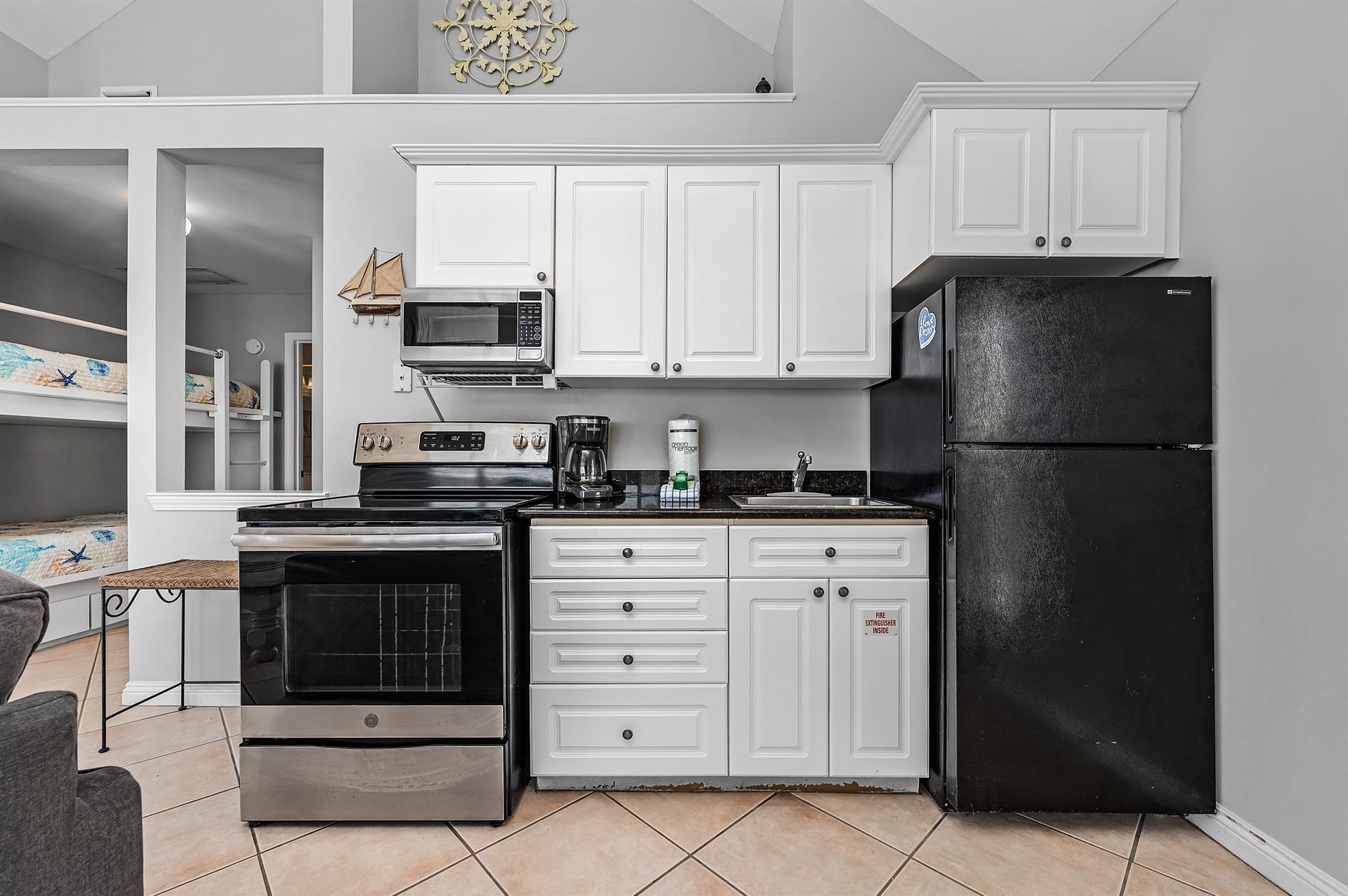 69 Crystal Beach Drive, Unit 8 Destin, FL 32541 - Photo 12 of 51 a kitchen with cabinets and appliances
