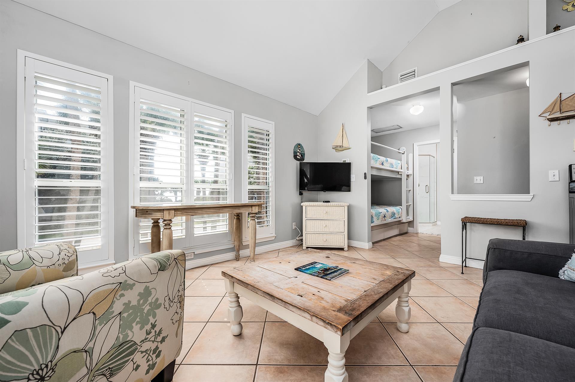 69 Crystal Beach Drive, Unit 8 Destin, FL 32541 - Photo 19 of 51 a living room with furniture and a flat screen tv