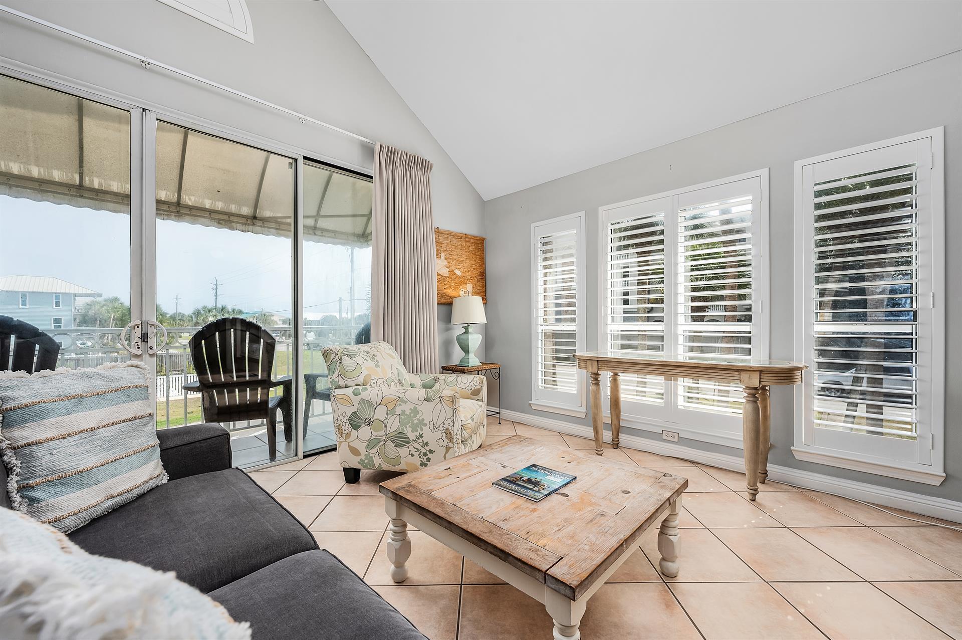 69 Crystal Beach Drive, Unit 8 Destin, FL 32541 - Photo 20 of 51 a living room with furniture and floor to ceiling windows