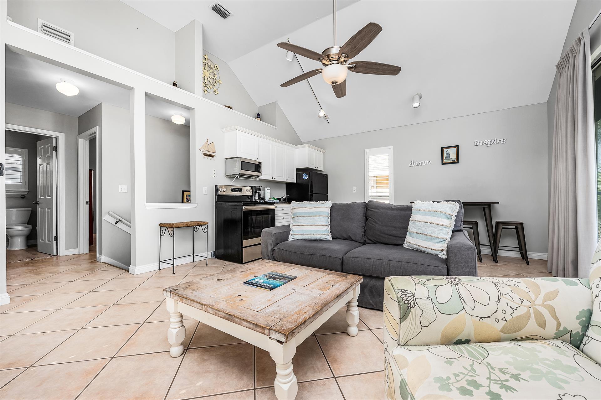 69 Crystal Beach Drive, Unit 8 Destin, FL 32541 - Photo 22 of 51 a living room with furniture and a chandelier