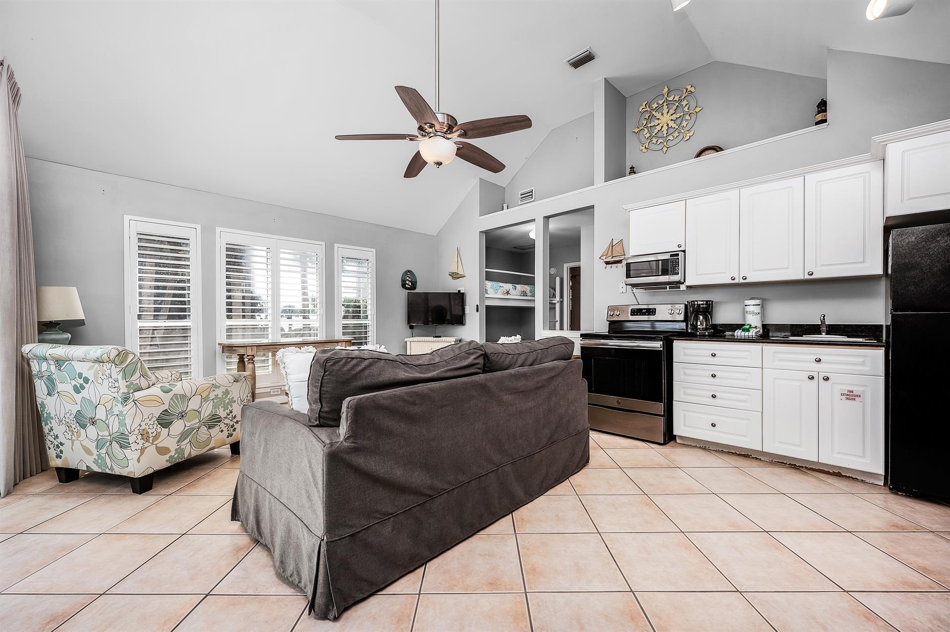 69 Crystal Beach Drive, Unit 8 Destin, FL 32541 - Photo 23 of 51 a living room with furniture and kitchen view