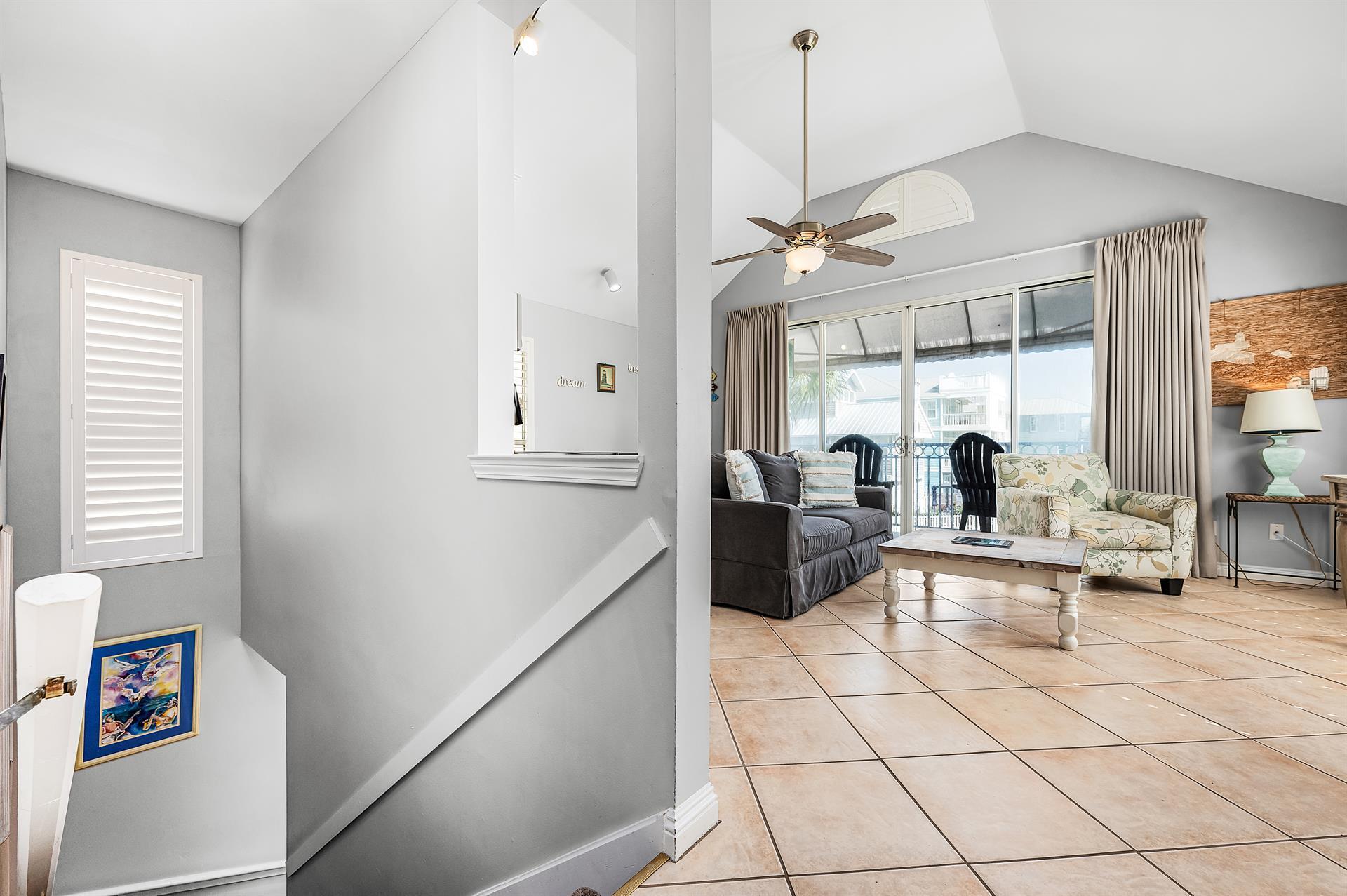 69 Crystal Beach Drive, Unit 8 Destin, FL 32541 - Photo 24 of 51 a living room with patio furniture and a chandelier