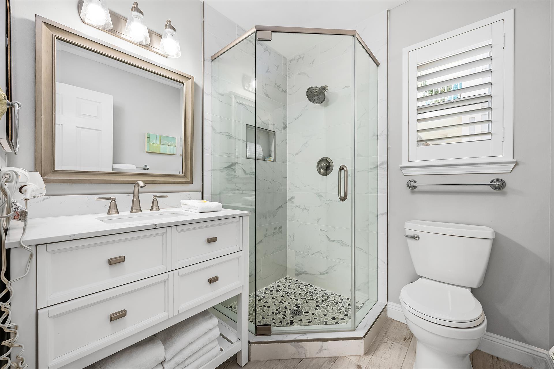 69 Crystal Beach Drive, Unit 8 Destin, FL 32541 - Photo 29 of 51 a bathroom with a shower sink vanity mirror and toilet