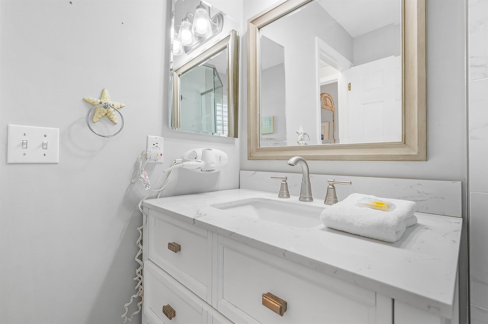 69 Crystal Beach Drive, Unit 8 Destin, FL 32541 - Photo 30 of 51 a bathroom with a sink and a mirror