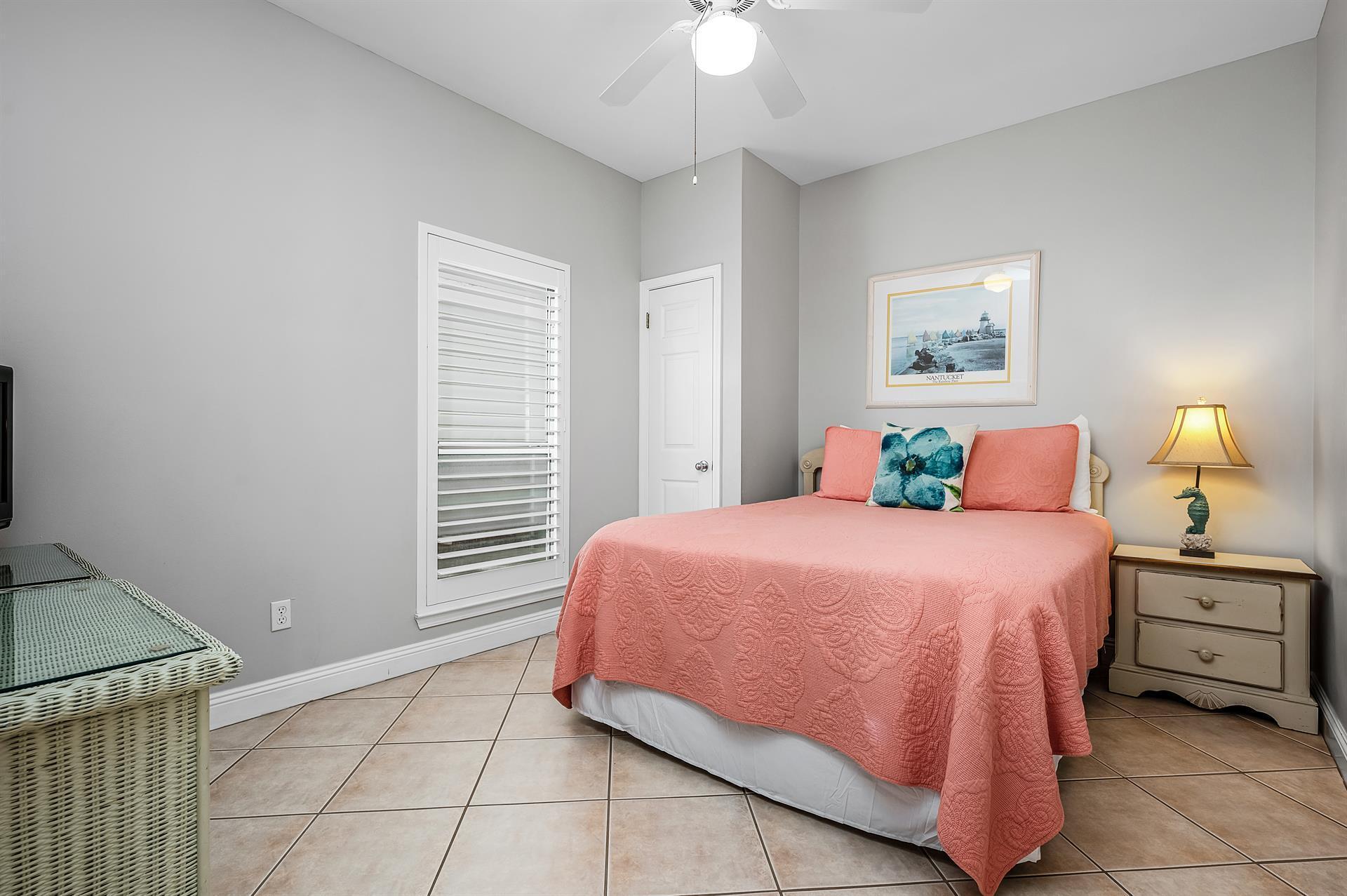 69 Crystal Beach Drive, Unit 8 Destin, FL 32541 - Photo 31 of 51 a bedroom with a bed and a window