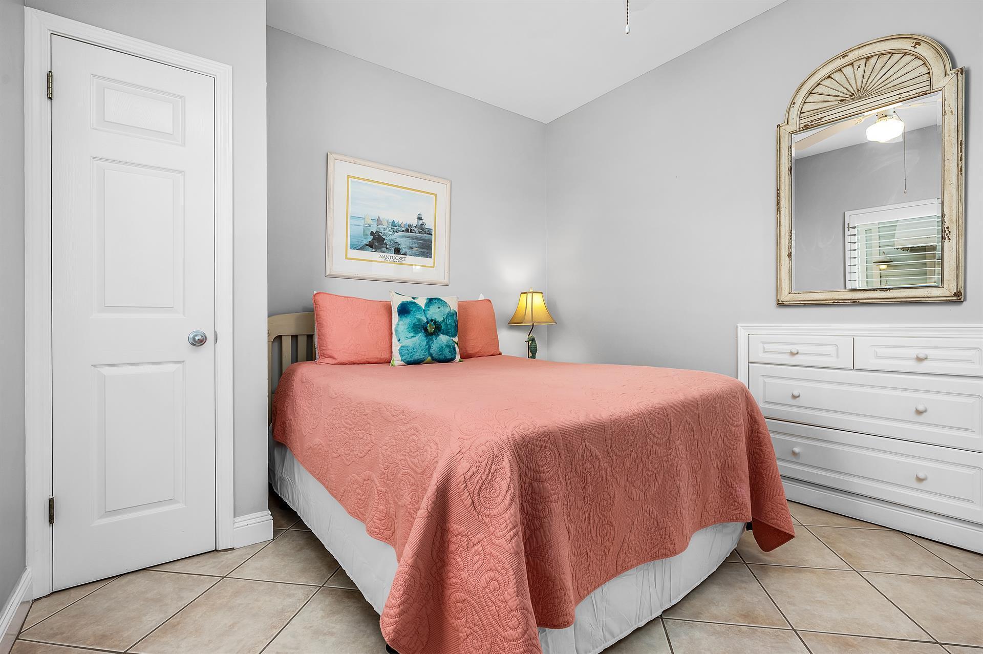 69 Crystal Beach Drive, Unit 8 Destin, FL 32541 - Photo 32 of 51 a bedroom with a bed and painting on the wall