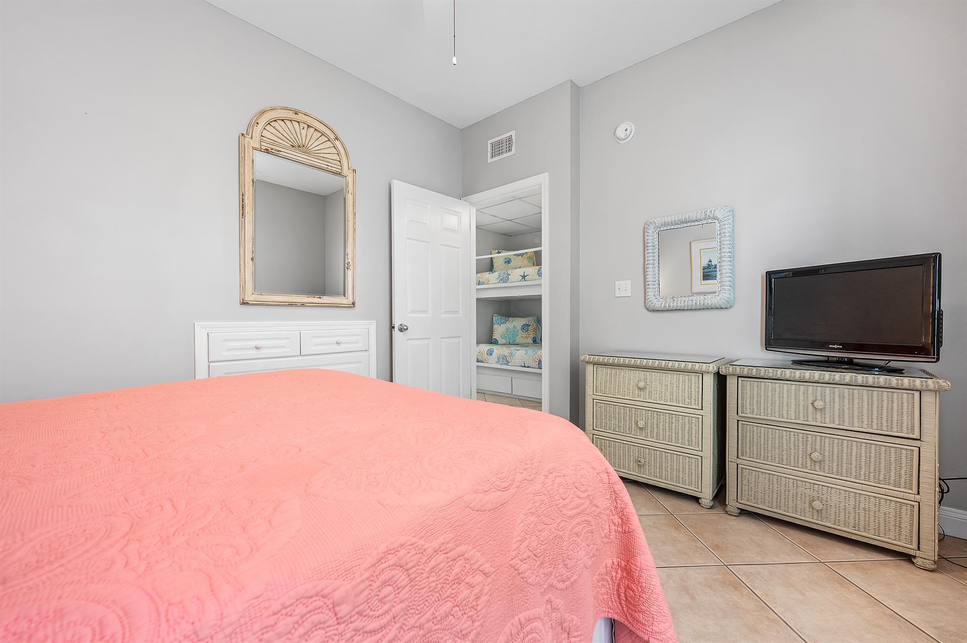 69 Crystal Beach Drive, Unit 8 Destin, FL 32541 - Photo 33 of 51 a bedroom with a bed and a flat screen tv