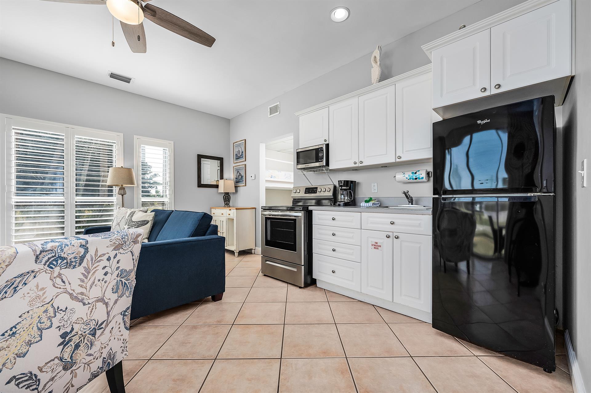 69 Crystal Beach Drive, Unit 8 Destin, FL 32541 - Photo 39 of 51 a kitchen with a refrigerator a stove top oven a sink and cabinets