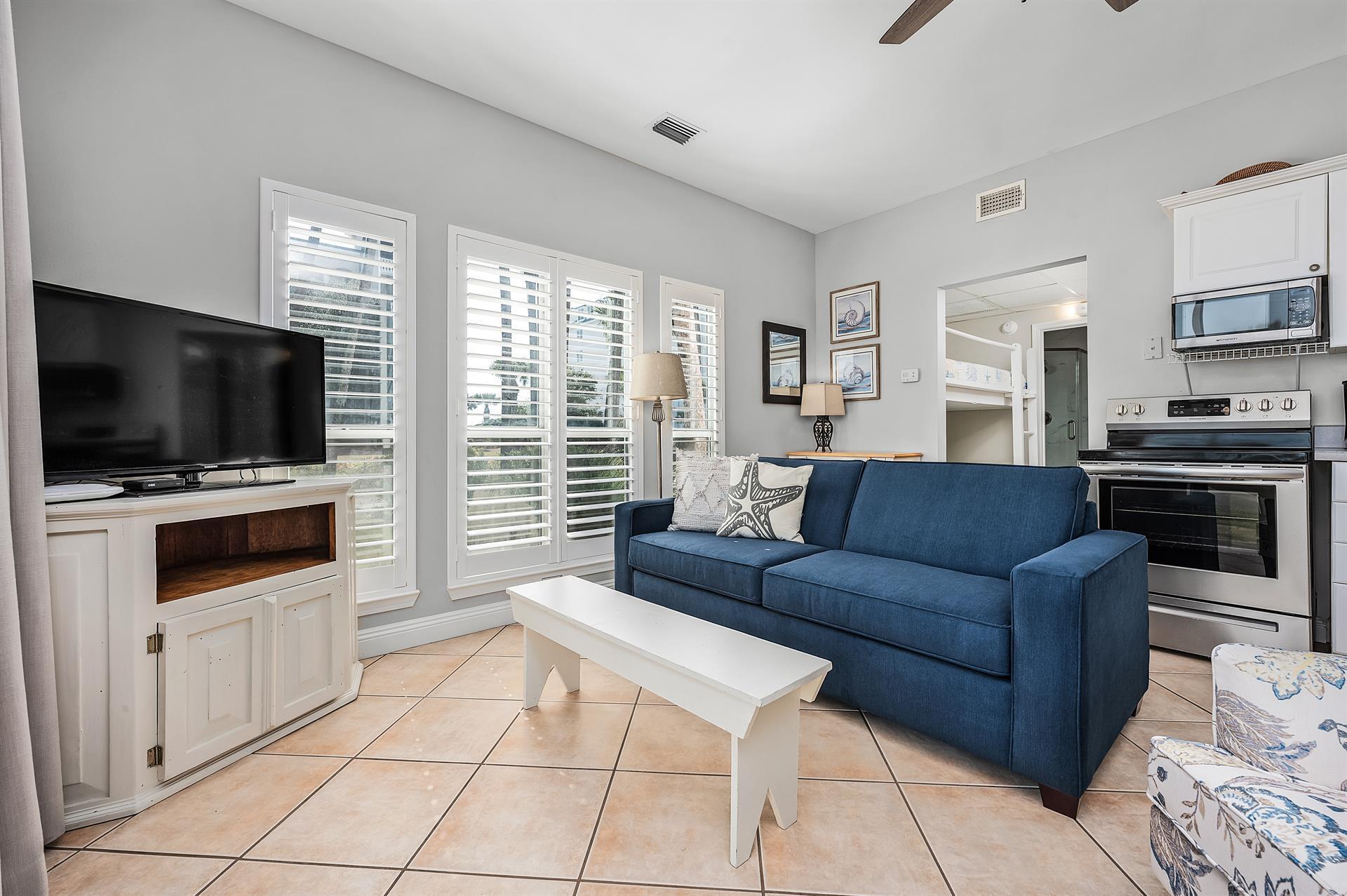 69 Crystal Beach Drive, Unit 8 Destin, FL 32541 - Photo 42 of 51 a living room with furniture and a flat screen tv