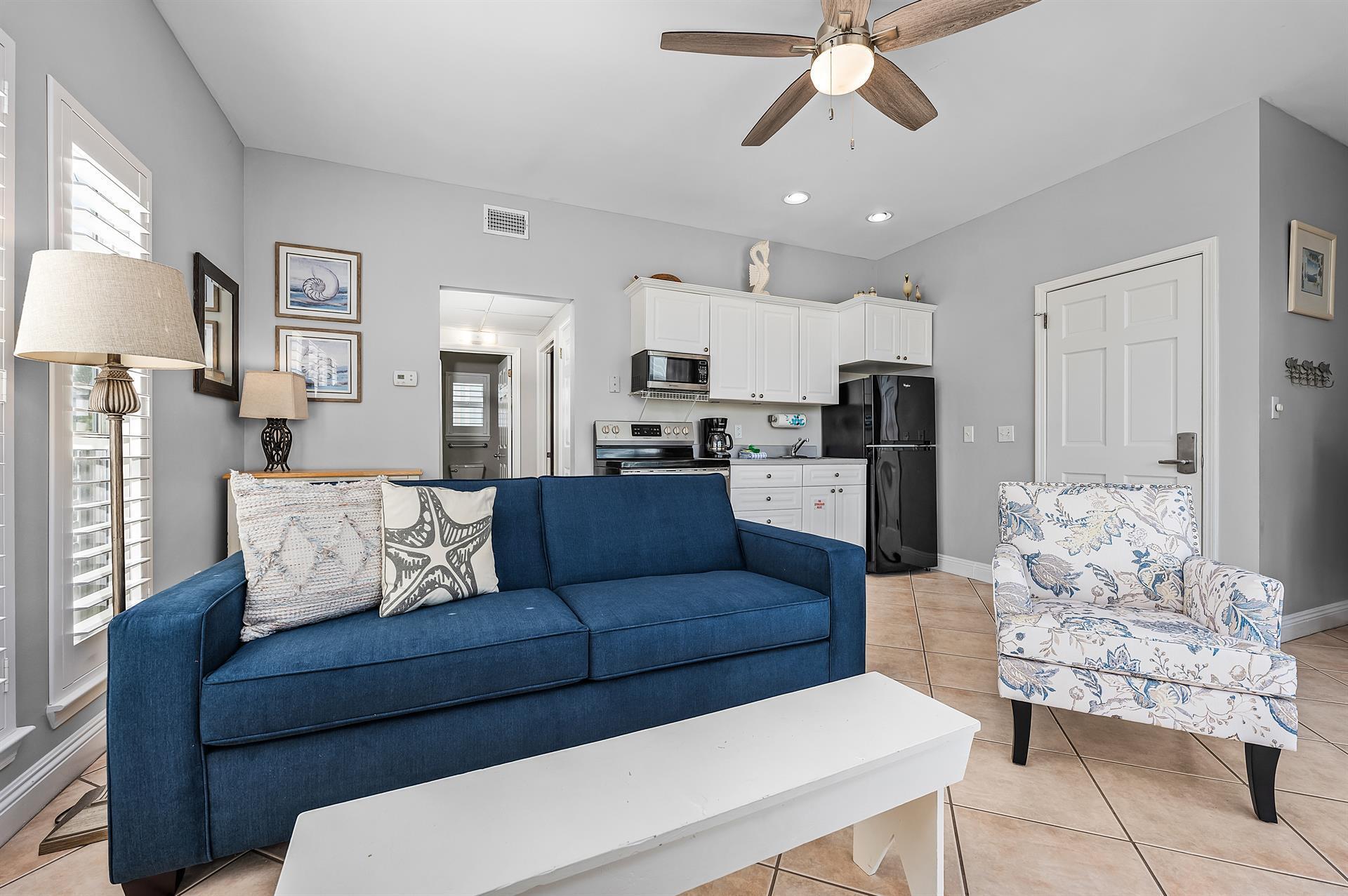 69 Crystal Beach Drive, Unit 8 Destin, FL 32541 - Photo 43 of 51 a living room with furniture kitchen view and a chandelier