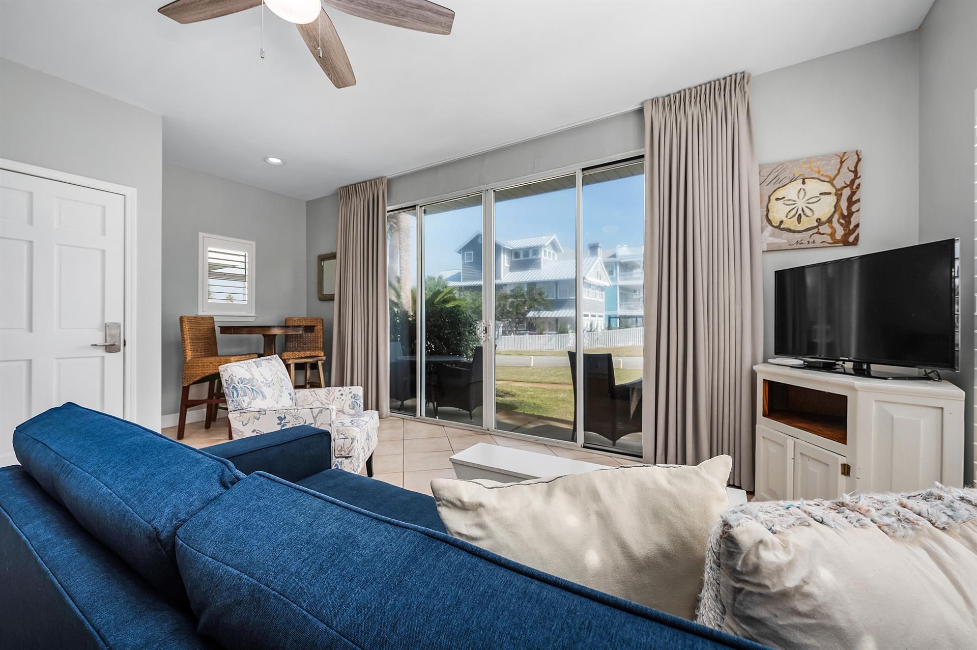 69 Crystal Beach Drive, Unit 8 Destin, FL 32541 - Photo 45 of 51 a bedroom with furniture and a flat screen tv