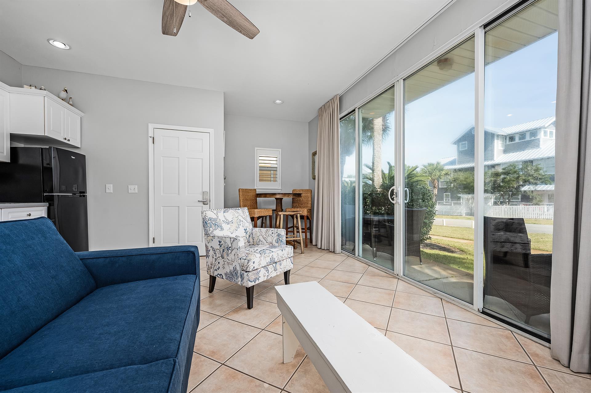 69 Crystal Beach Drive, Unit 8 Destin, FL 32541 - Photo 46 of 51 a living room with furniture and a floor to ceiling window