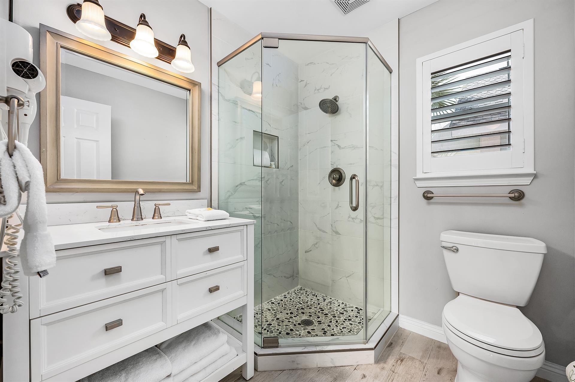 69 Crystal Beach Drive, Unit 8 Destin, FL 32541 - Photo 7 of 51 a bathroom with a shower a sink and a toilet