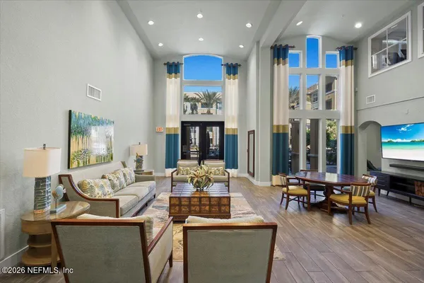 a living room with furniture and wooden floor