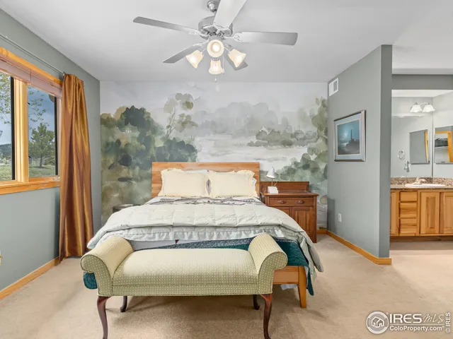 a bedroom with a bed mirror and window