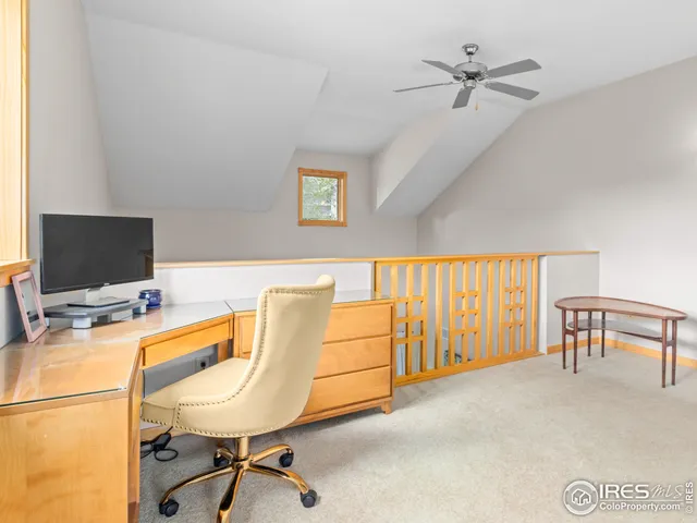 a workspace with a table chair and a couch