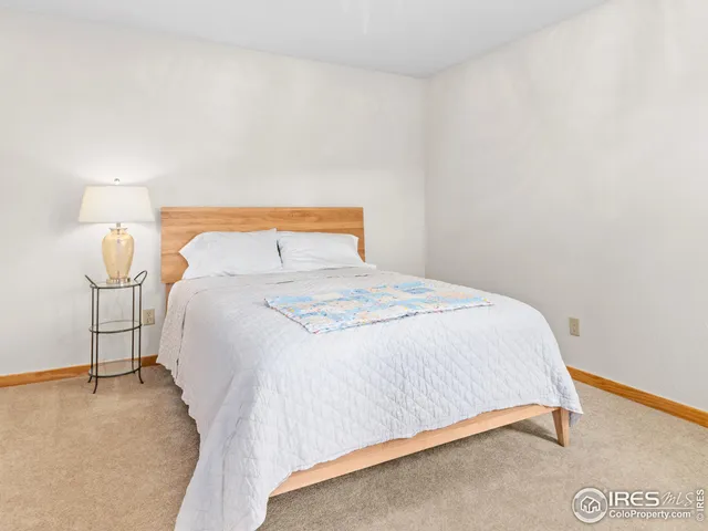 a bedroom with a bed and a night stand