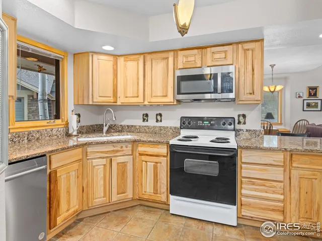 a kitchen with stainless steel appliances granite countertop a stove and a sink