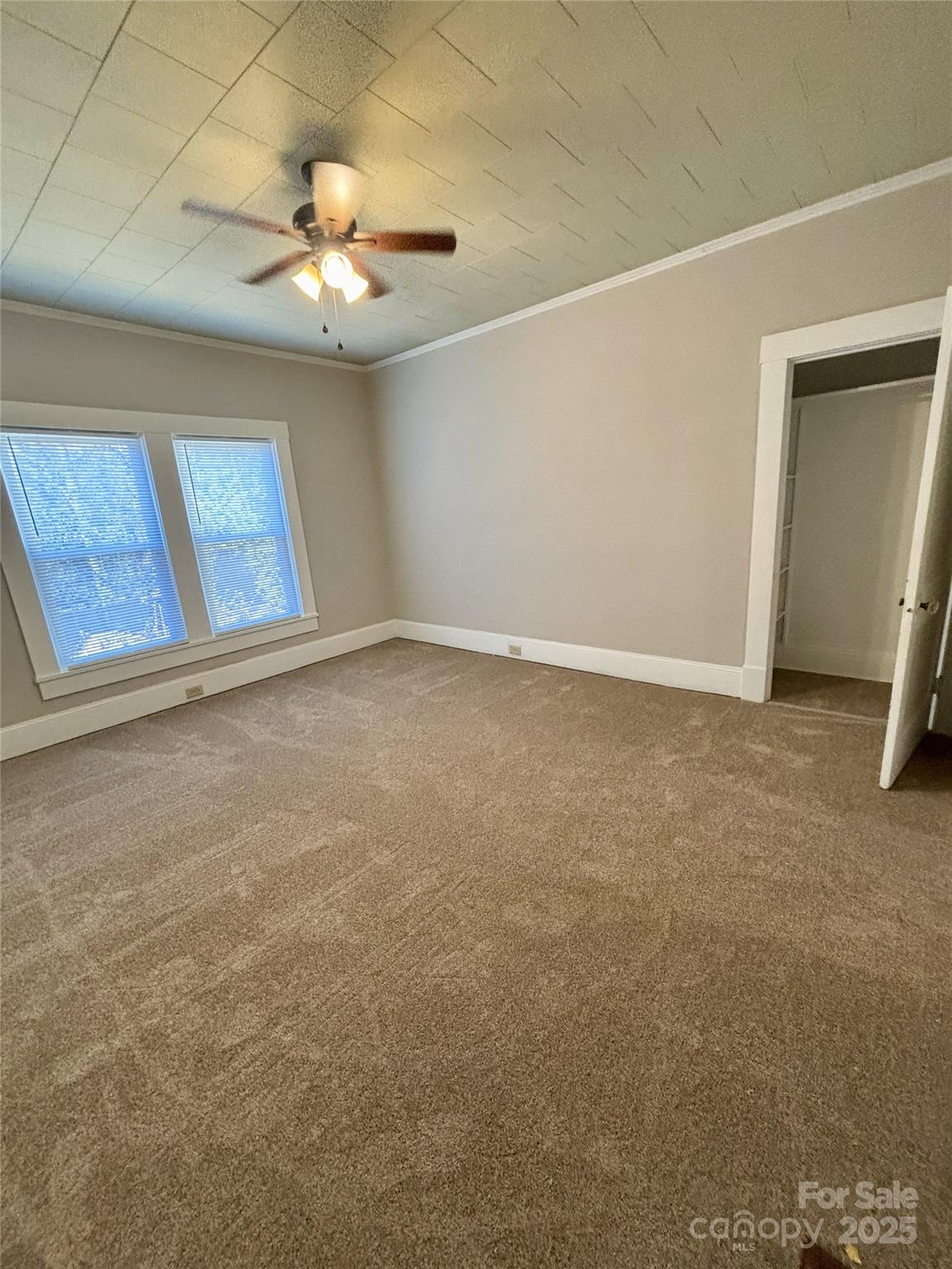 455 Spring Street Albemarle, NC 28001 - Photo 15 of 32 a view of an empty room with a chandelier fan