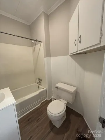 a bathroom with a toilet a sink and bathtub
