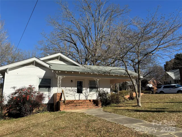 a view of a house with backyard porch and sitting area