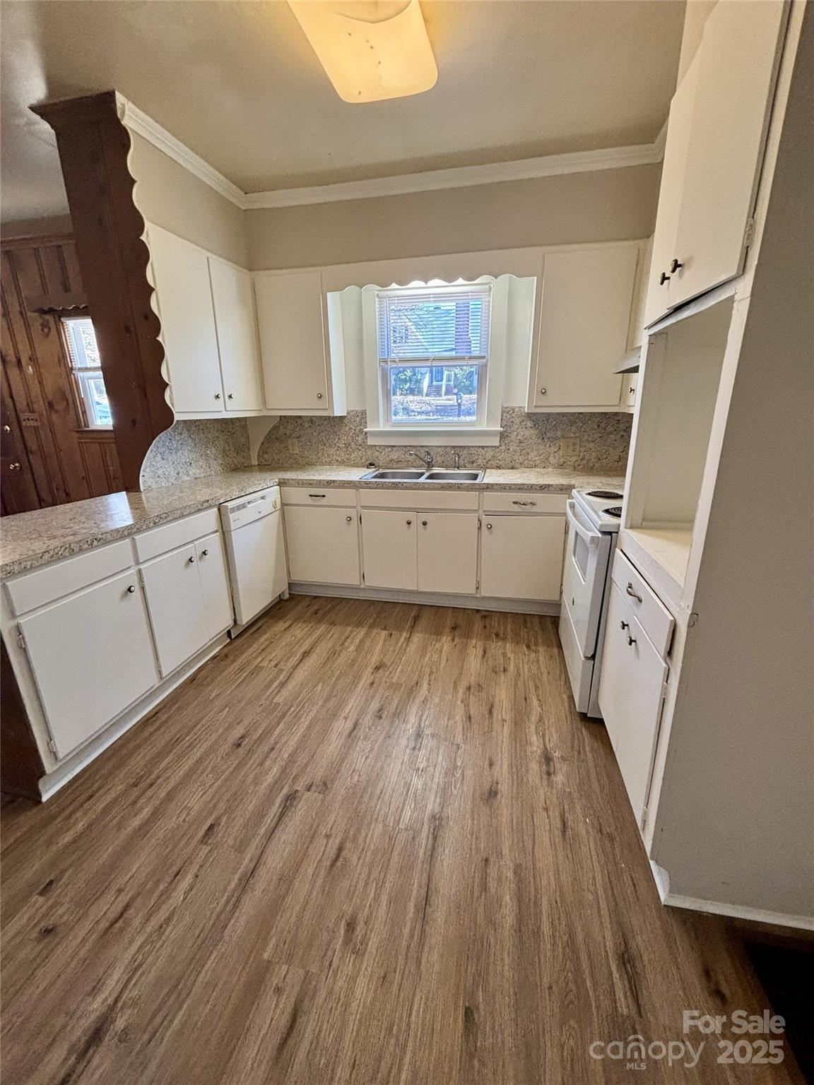455 Spring Street Albemarle, NC 28001 - Photo 21 of 32 a kitchen with cabinets a sink and wooden floor